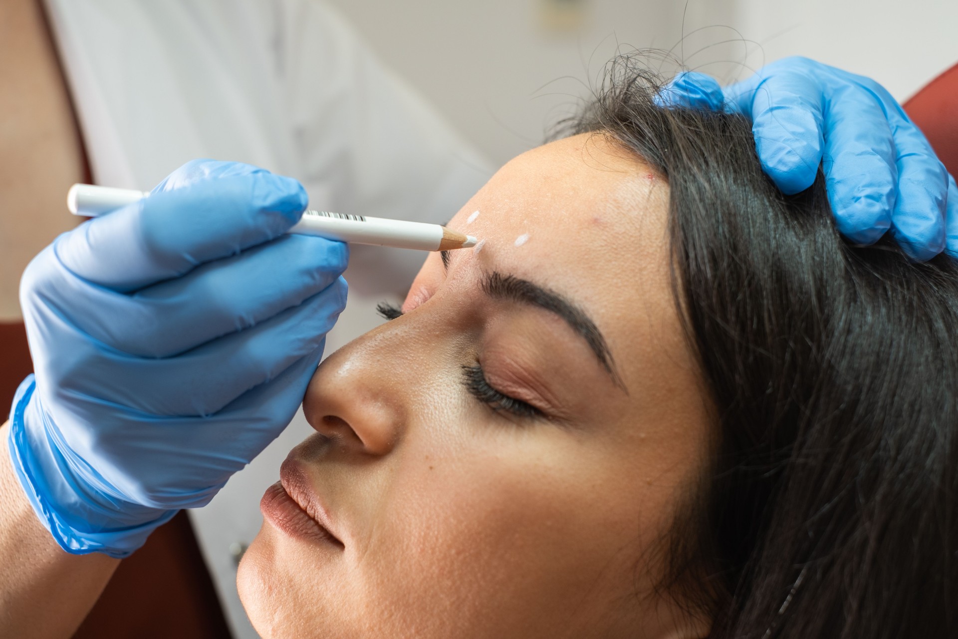 Dermatologist Drawing Marks on woman's face